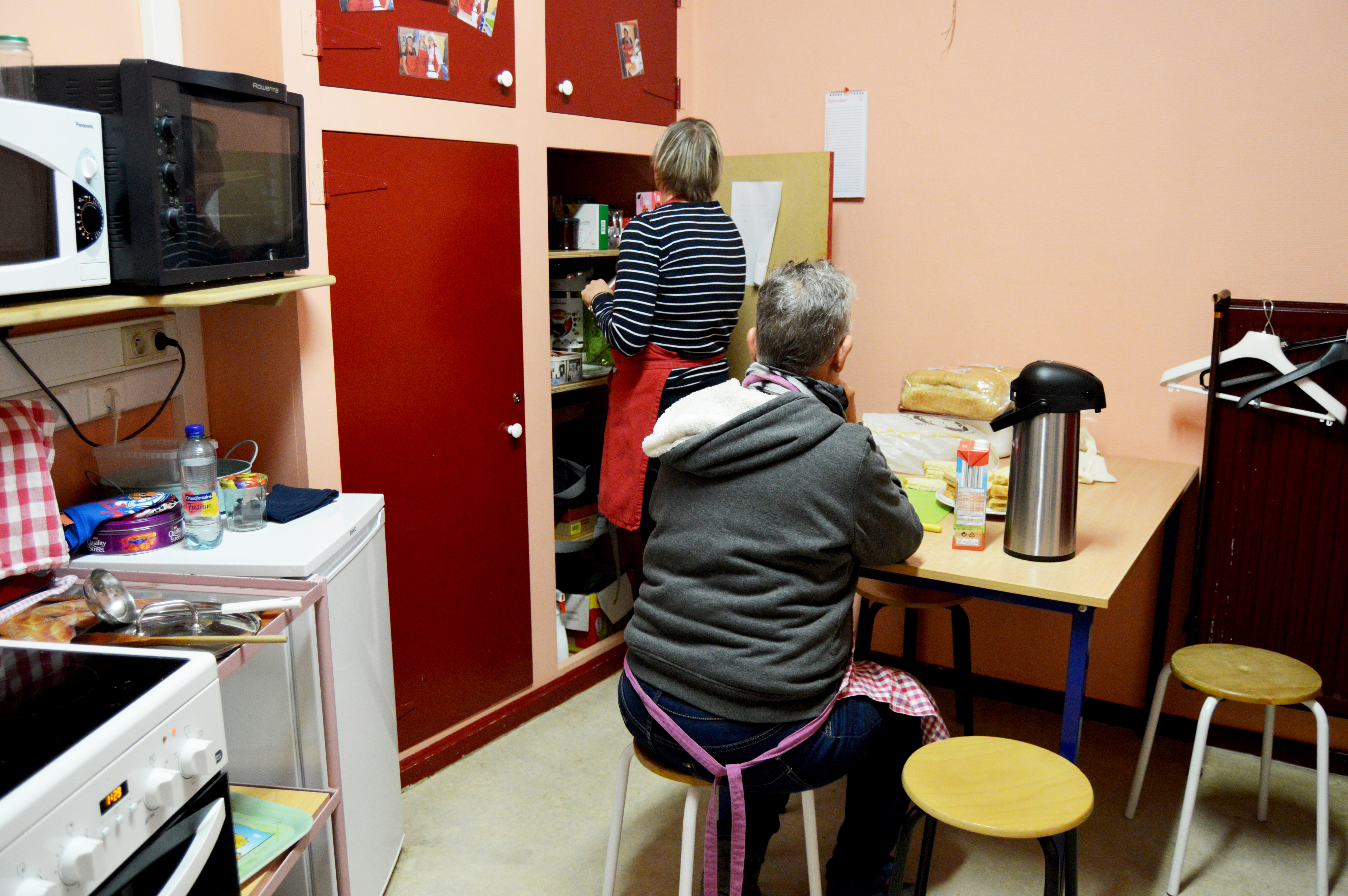 Deux personnes dans la cuisine de l'ASBL en train de préparer le potage du jour.