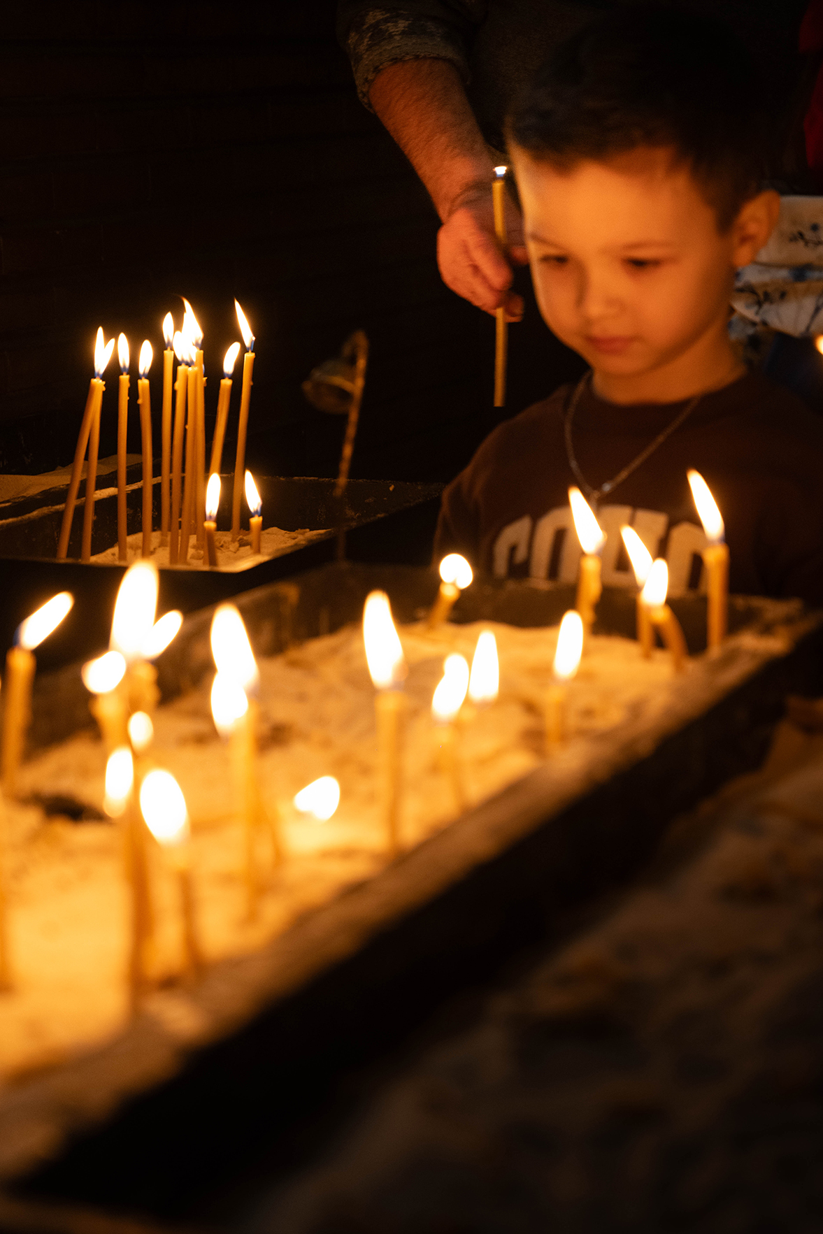 A child watching candles burn
