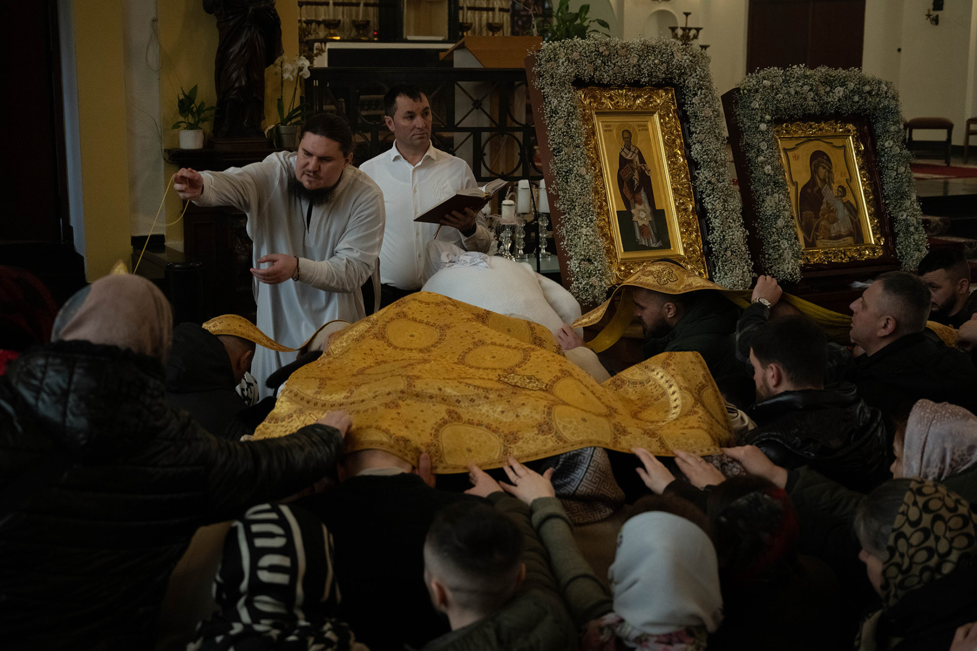 Archpriest Dimitry giving liturgical clothes to the people